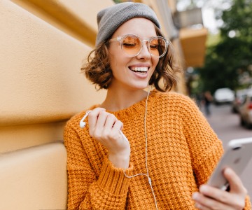 A smiling person with headphones